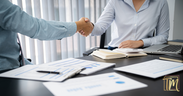 Aperto de mãos representando a formalização da contratação de funcionário com registro em carteira
